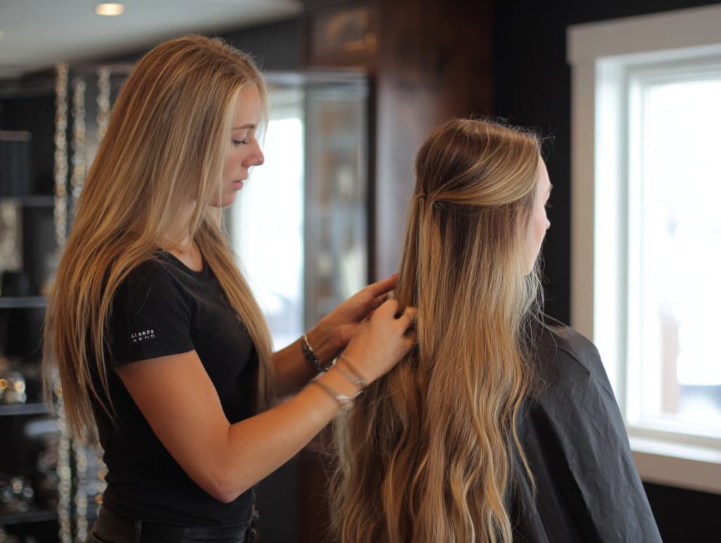 Professional hair extension aftercare guidance at a luxury salon