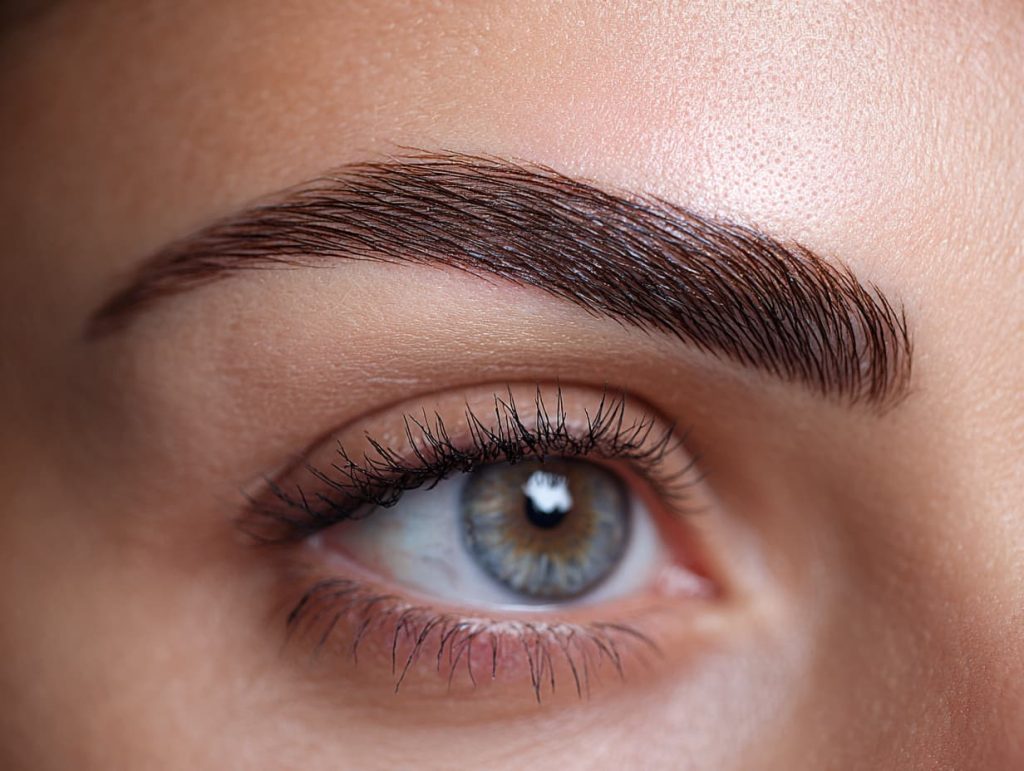 Healed natural brows after microblading aftercare showing even pigment and soft strokes